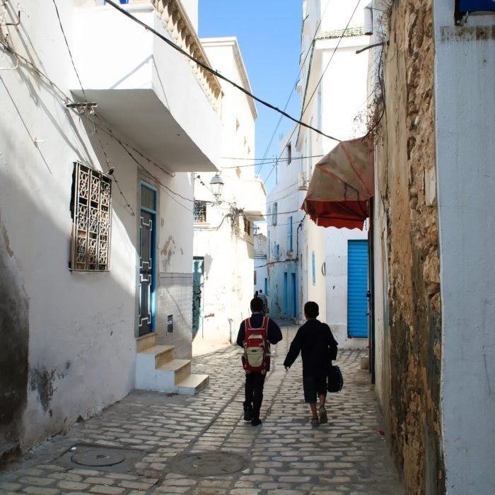 Two students go to school on the street of the old town of Sousse, Tunisia.